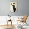 Elegant woman painting displayed in a minimalist reading nook with wooden furniture and neutral tones.
