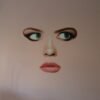 Modern face art featuring a surrealistic woman’s face with blue eyes and soft lips on a minimalist canvas.