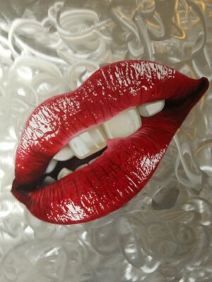 Pop art painting of glossy red lips pop art painting on brushed aluminum with a textured silver background.