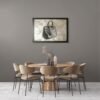 Luxury handbag painting accenting a dining room with a round wooden table and velvet chairs