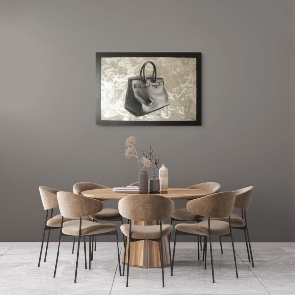 Luxury handbag painting accenting a dining room with a round wooden table and velvet chairs