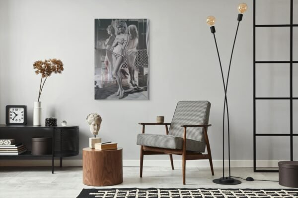 Black and white wall art featuring a vintage-inspired portrait of a woman, displayed in a modern, minimalist living room.
