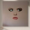 Modern face art of a surreal woman’s portrait with blue eyes and soft lips, highlighted by natural light and shadows.