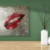 Red lips pop art painting on a textured silver background, displayed on a green wall with minimalist vases for decor.