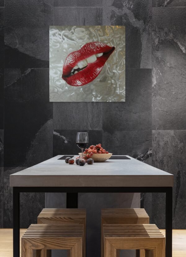 Red lips pop art painting on a textured silver background, displayed on a dark wall above a modern kitchen table.
