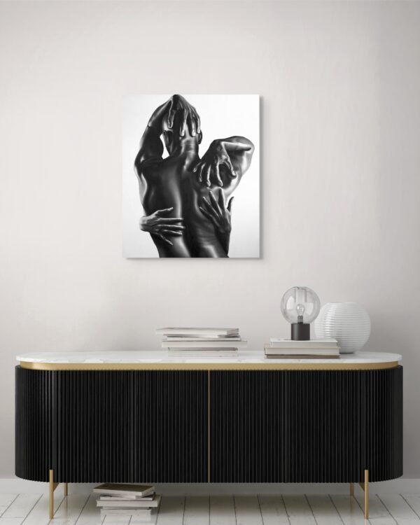 A black-and-white figurative painting depicting an intimate embrace, showcased above a sleek modern console with minimalist decor.