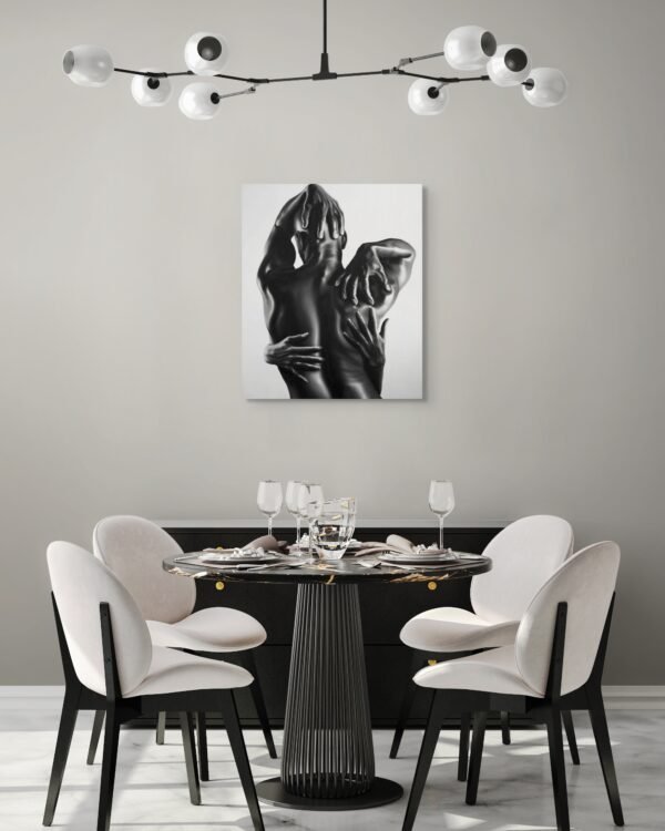 Black-and-white figurative painting of an embrace displayed in a modern dining room with minimalist decor and contemporary chandelier lighting.