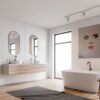 Modern face art painting of a surreal woman’s portrait displayed in a minimalist bathroom with a freestanding tub and wooden accents.